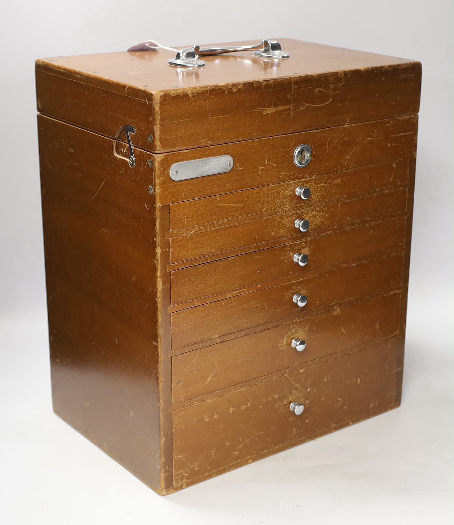 An early 20th century teak dental cabinet, glass lined drawers with chrome fittings, some dental implements included, dimensions, 40 x 33 x 23cm